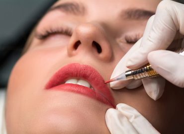 Permanent make up procedure. Lip makeup in tattoo salon.